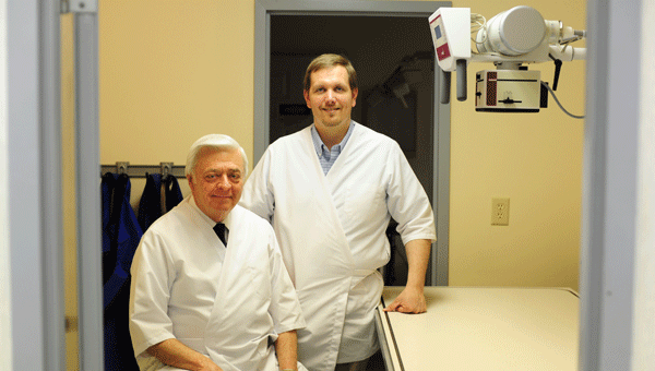 Veterinarians Dr. Charles Thornburg and Dr. Fred Self at the Shelbiana Animal Clinic recently installed a new digital x-ray machine at their clinic in Columbiana. (Reporter Photo/Jon Goering)