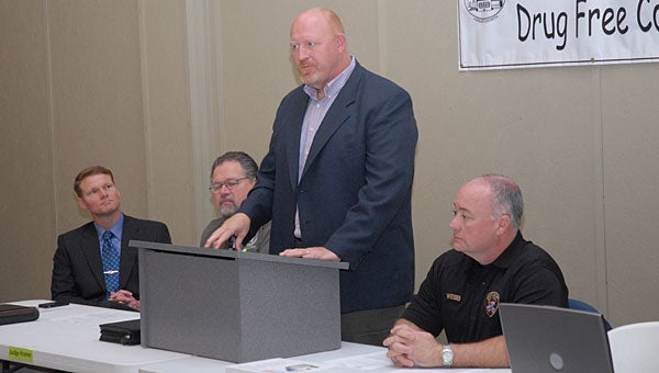 Lonnie Layton with Bradford Health Services, standing, speaks during a March 14 Shelby County Drug Free Coalition Meeting as, from left, Shelby County Sheriff's Office Commander Chris George, Judge Jim Kramer and Sheriff's Office Sgt. Keith Webb look on. (Reporter Photo/Neal Wagner)