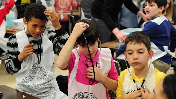 Riverchase Elementary third-graders learn about the proper, and improper, uses of a stethoscope during UAB's PhUn week at the school on March 20. (Reporter Photo/Jon Goering)
