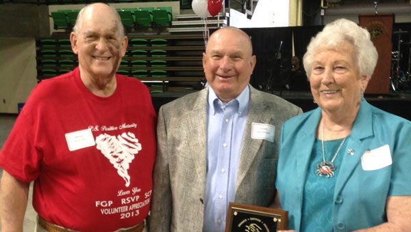 Marvin Copes, left, the coordinator of RSVP Shelby County,  presents awards to Lloyd and Anita Davenport. (Contributed)