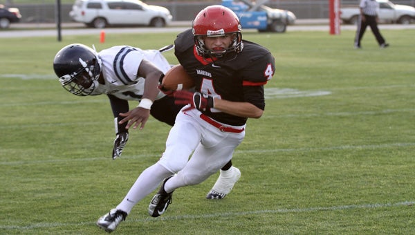 Thompson's Matt Tolbert hauls in a pass from Zack Brammer to turn it into a 78-yard touchdown in a spring game May 16. (Reporter Photo/ Eric Starling)