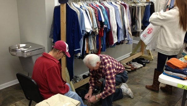 Calera Acts of Kindness volunteer Jerry Mahon helping a young man with shoes at the Spring 2013 giveaway. (contributed)