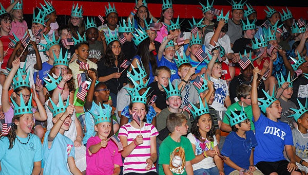 Thompson Intermediate School fifth-graders cheer as Lady Liberty appears in the school's gymnasium on Sept. 18. (Reporter Photo/Neal Wagner)