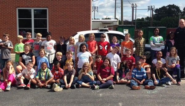 Brandi Little’s fourth grade class with Calera Police Officer Jay Cardwell. (contributed)