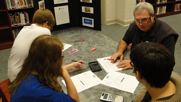 Joe Sullivan of Sullivan Communications helps Calera High School freshmen with their grocery budgets for the Keeping It Real program sponsored by the Greater Shelby County Chamber of Commerce. (contributed)