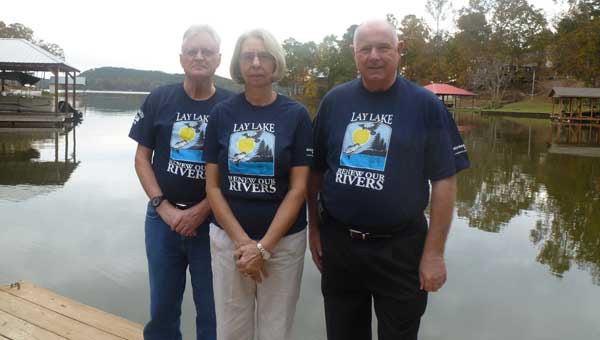 Lay Lake HOBO officers Secretary Frank and Judy Jones, cleanup chair, and President Art Giddens wear their HOBO T shirts "Lay Lake - Renew our Rivers" on Jones' dock on Lay Lake.