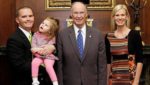 Officer Dustin Chandler, left, his wife, Amy, with Gov. Robert Bentley who is expected to sign Carly's Law in the coming weeks. (File)