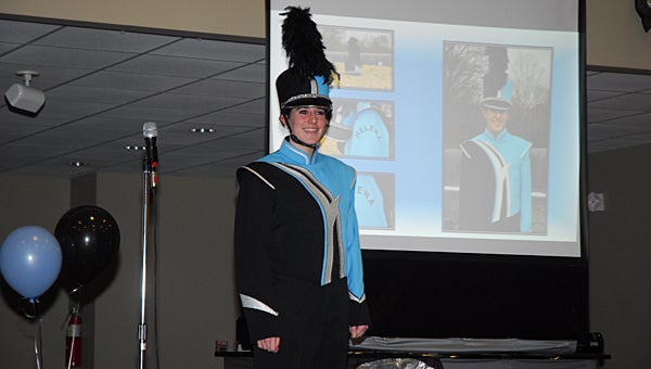 Caroline Hull, daughter of Helena Band Booster President Jan Hull, models Helena High School's first band uniform during a Jan. 19 meeting at the Helena Community Center. (Reporter Photo/Neal Wagner)