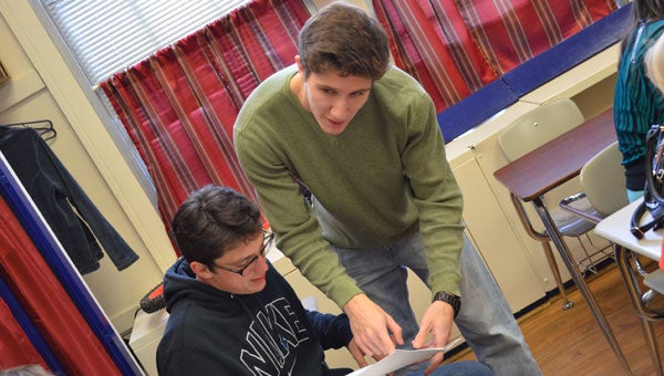 MHS senior AP calculus students Chase Hamrick and Zach Tutwiler review a homework assignment. (contributed)