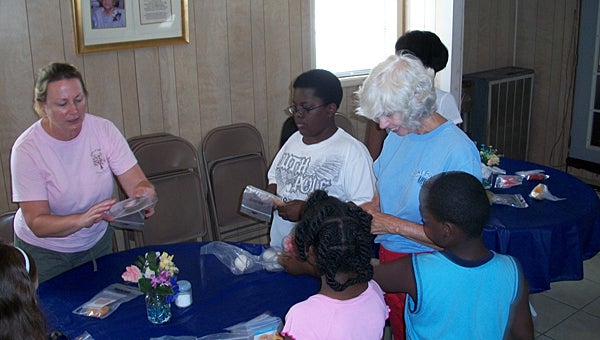 Sowers of Seed volunteers serve local children during the summer of 2011. The charity will again help children in need this summer. (Contributed)