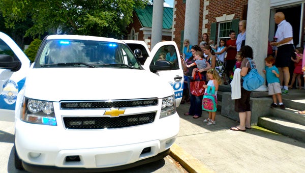 Children got an inside look at a police car during the annual Visit with the Police Department event held by the Jane B. Holmes Public Library on June 25 at Helena's City Hall. (Reporter Photo / Molly Davidson)