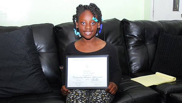 Rising Alabaster fourth-grader Kennadi Alexander displays a certificate she received from the White House last month. (Reporter Photo/Neal Wagner)