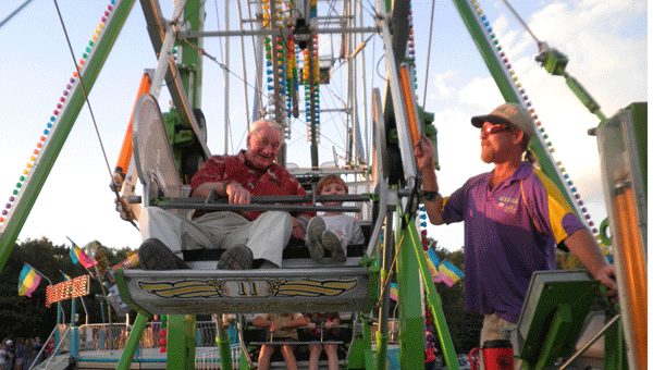 Red Robinson and grandson Tripp ride the ferris wheel at the fair. (Contributed)