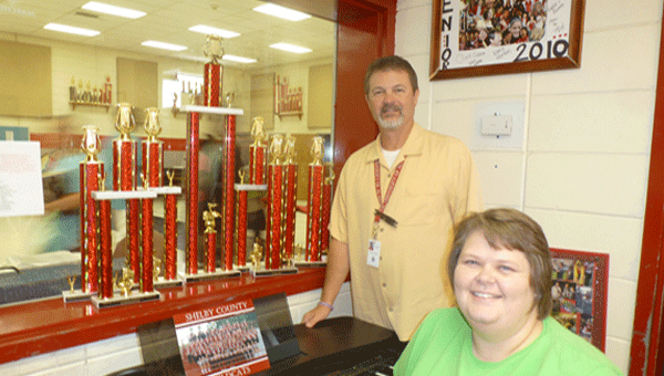 SCHS Band Director Tom Grigsby and SCHS Band Booster President Renee' Wilder in Grigsby's office with the Pride of Shelby County Band trophies. (Contributed)