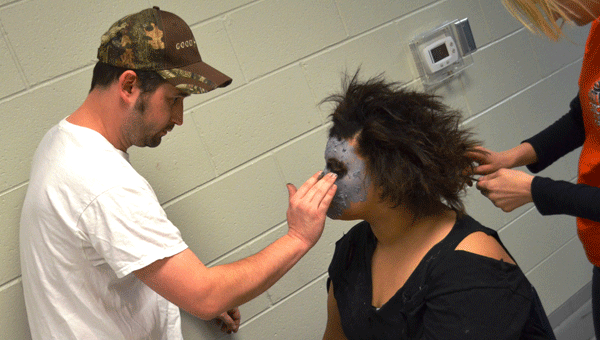 Pictured is junior theatre student Dakota Mitchell having zombie make-up applied prior to the performance.