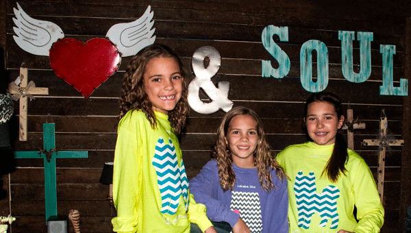 'Happy Heart & Soul customers sporting new Husky-themed T-shirts are sisters Peyton, Julia and Grace Wilkins.'