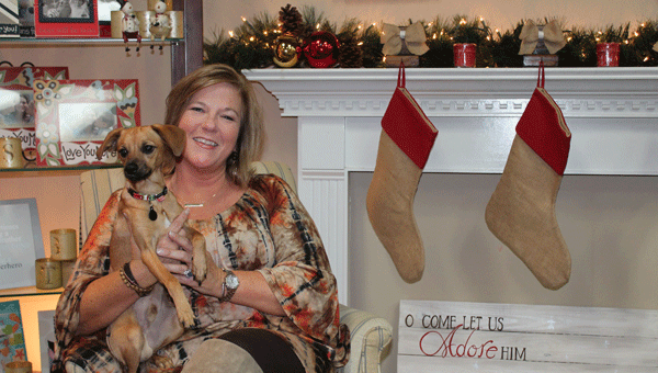 Gifted owner Paige Burnett sits by the fireplace with her dog, Gunter.