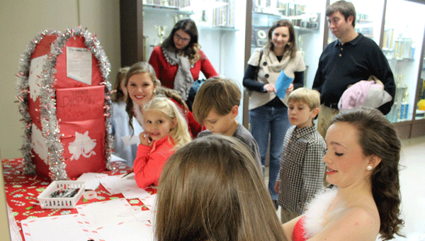 Dancers, PHS visual ensemble members and children pen letters to Santa to participate in the Macy's Believe Make-a-Wish Foundation campaign following the 2014 Holiday Visual Ensemble Showcase. 
