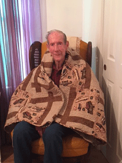 WWII Vet Jefferson Wiley Edmondson sits in his home covered with his Quilt of Valor made and presented by Sarah Atchison at a surprise ceremony attended by family and friends at The Church of Columbiana, co-pastored by Leslie and Teresa Whiting. 