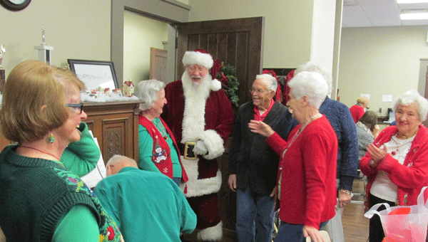 Santa joins a group in singing songs at a Christmas party at the Alabaster Senior Citizens Center on Dec. 18.  