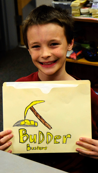 Pictured here is HIS fourth grader, Chris H., a Helena Intermediate Gifted Resource Class student, with his team’s Budder Busters information folder for the Gold Rush Project. (Contributed)
