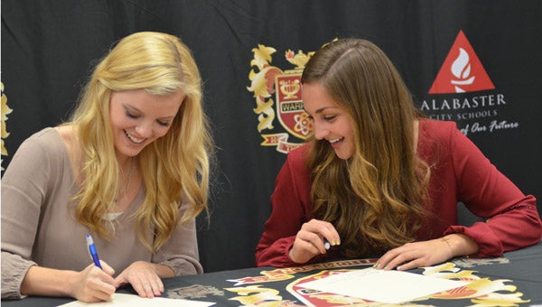 Amber Harless (left) and Brittany Yoder signed letters of intent on Feb. 2 to play soccer next year with Troy University (Reporter Photo / Baker Ellis)