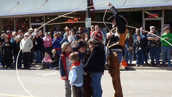Cowboy Bruce Brannen will perform his Wild West Show at the Seventh Annual Columbiana Cowboy Day on Feb. 21st at 12:15 p.m. Pictured are children encircled with Cowboy Bruce's lariat at Cowboy Day 2014 on Main Street. (Contributed)