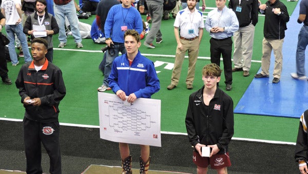 Aaron Ledbetter, center, stands atop the 6A 120-pound weight class at the state tournament in Huntsville on Feb. 14. (Contributed)