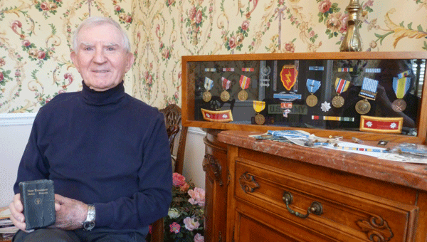 Lt. Col. (Ret.) Gene Dekich sit next to his medals and holds the small Bible that he carried in Army uniform shirt pocket filled with his personal notes from his combat tour during the Korean War. He is a mustanger, the military term for entering the U.S. Army as an enlisted man and retiring as an officer. (Contributed)