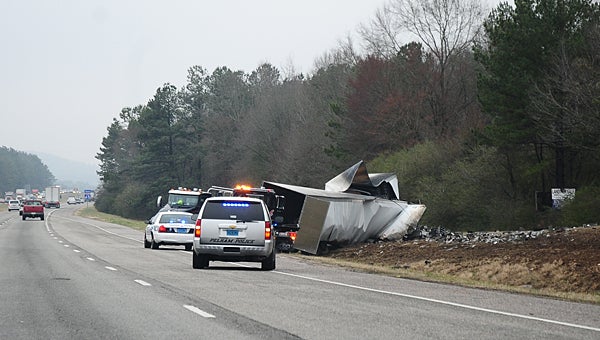 Pelham police and wrecker crews work to clear an 18-wheeler wreck on Interstate 65 near mile marker 242 at about 8:30 a.m. on Feb. 23. (Reporter Photo/Neal Wagner)