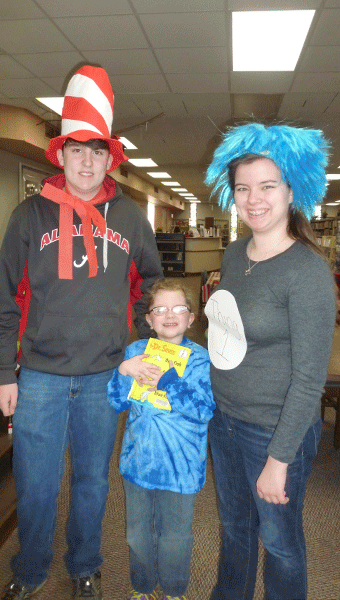 Shelby County High School students and members of the Columbiana Public Library Teen Advisory Board Landon Bentley and Faryn Fryer with Elvin Hill School student Gabbie Payne at the Dr. Seuss party at the library. (Contributed)