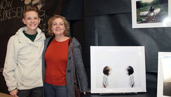 State Photography winner Aaron Squires and his mom, Lisa, enjoy photography and art displayed at PHS. (Contributed)