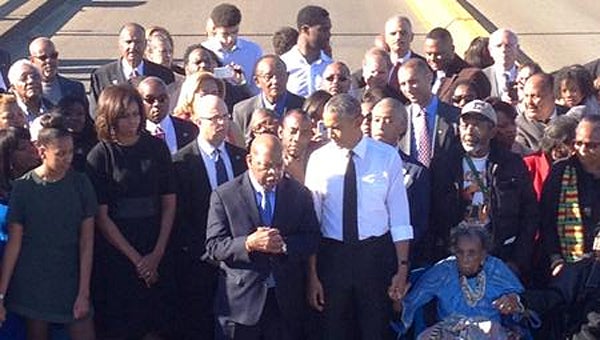Thompson High School graduate Tammy Williams, far left, third from front, marches alongside President Barack Obama and the first family in Selma on March 7. (Contributed)