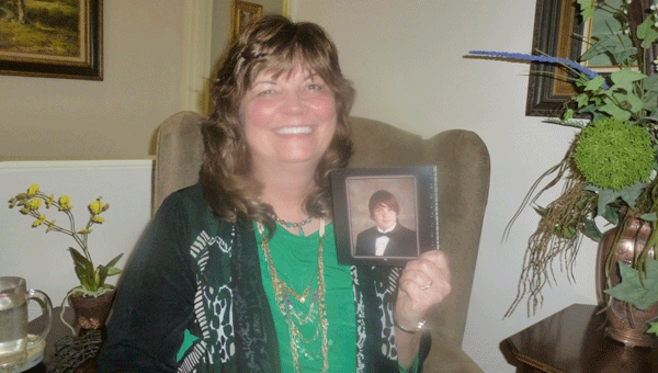 Linda Coogan holds a picture of her son Joshua Smith, graduate of Pelham High School, who was murdered along with two friends in Coogan's home on Sept. 12, 2012. (Contributed)