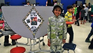 Preston Bishop, dressed as Colin Powell, shows off his informational kite about Powell. (Reporter Photo / Molly Davidson)