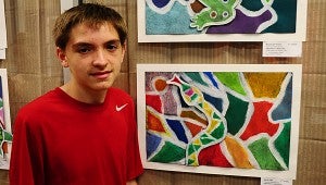 Thompson Middle School seventh-grader Gavin Hall displays his painting at Pelham's IberiaBank during a May 12 reception. (Reporter Photo/Neal Wagner)