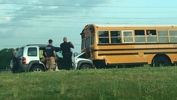 Pelham police and firefighters work to clear a wreck involving a Pelham school bus on the morning of May 12. (Contributed/@williswatkins)