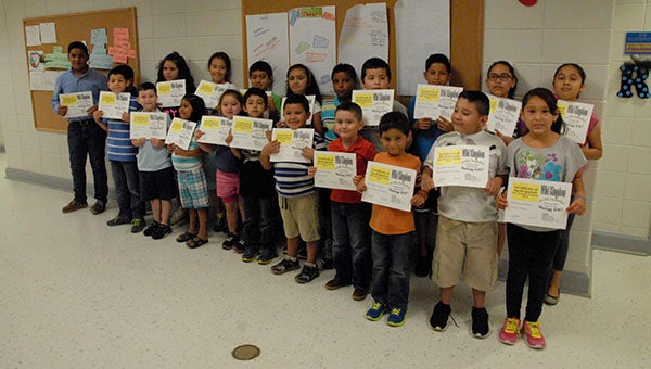 Helena students pose for a picture with their certificates of completion after finishing a two-week ESL Camp. (Reporter Photo/Graham Brooks)