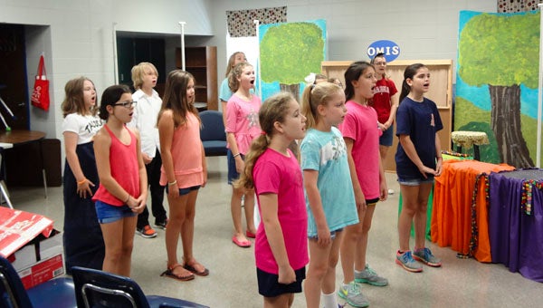 Students warm up their voices for a rehearsal of "Return of the Glass Slipper" at a Shelby County Schools musical theatre enrichment camp at Oak Mountain Intermediate School on June 25. (Reporter Photo/Emily Sparacino)