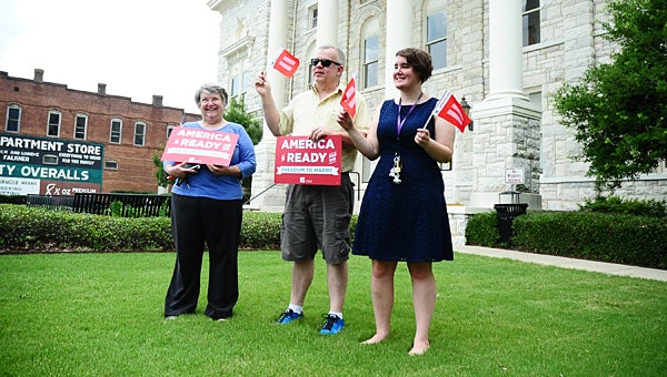 From left, Sally Smith, David Haws and Leslie Smith (no relation) rally at the Shelby County Courthouse in support of a Supreme Court ruling ordering states to issue same-sex marriage licenses on June 26. (Reporter Photo/Neal Wagner)