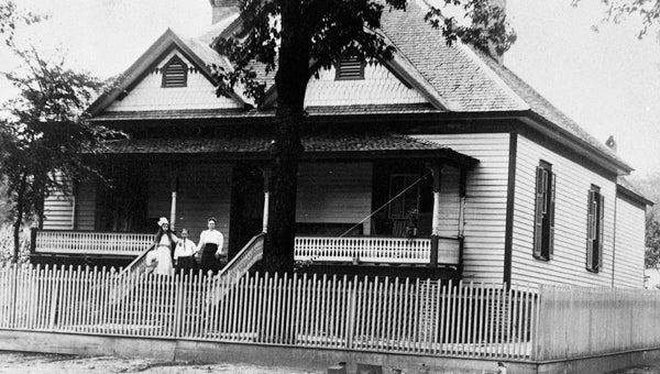W.S. Esco Family. Before laws requiring farm animals to be fenced, people erected fences around their homes to keep pigs, cattle and goats from wandering into their yards. The W.S. Esco family was photographed about 1910 in front of their animal proof house located next to the Helena School. This house was later destroyed in the 1933 tornado. (Contributed/City of Helena Museum)
