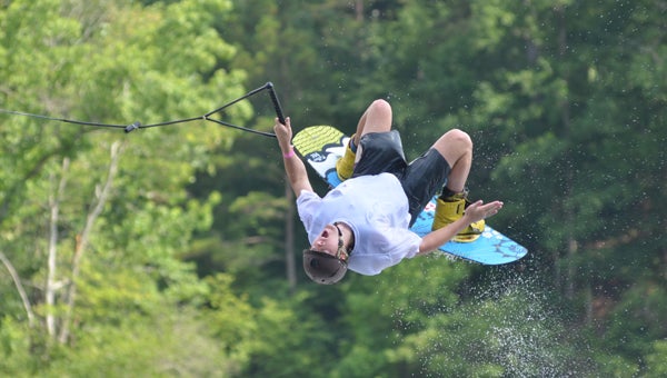 Calvin Miller, a rising senior at the University of Alabama, executes a backflip at Flipside Watersports in Oak Mountain State Park on June 10. (Reporter Photo/Baker Ellis)