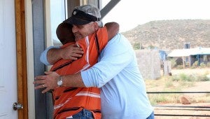 A new homeowner hugs DOCC member Kirk Cuevas. Cuevas was one of 26 DOCC members who traveled to Encenada, Mexico to build houses for local families. (Contributed)