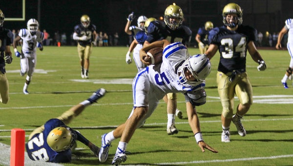 Matt Marquet falls forward into the end zone during Chelsea's 21-16 win at Briarwood in the opening game of the season for both teams. (For the Reporter / Dawn Harrison)