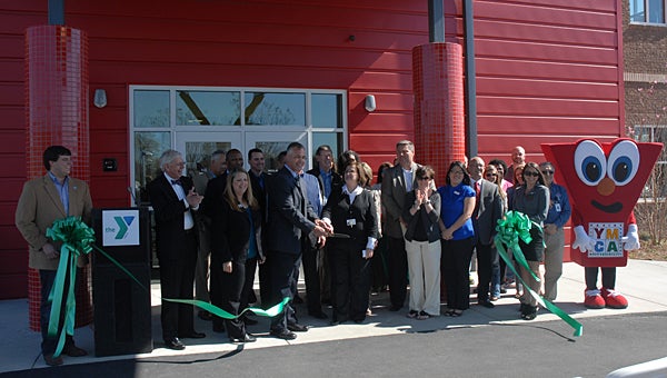 YMCA Regional Vice President Lane Vines and DAY Program Executive Director Kathy Miller, center, celebrate the opening of their new building in Alabaster in 2010. Local school systems will continue their support of the program during the next school year. (File)