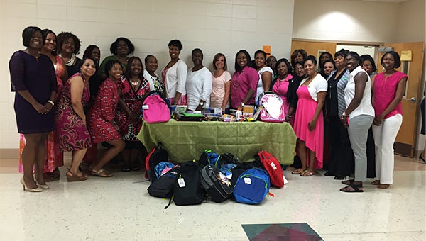 Members of the Psi Xi Omega chapter of the Alpha Kappa Alpha Sorority Inc. present 29 backpacks and school supplies to Thompson Middle School Principal Neely Woodley on Aug. 16. (Contributed)