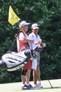 Former Secretary of State Condoleeza Rice talks strategy with her caddie. 