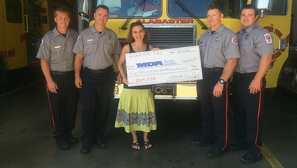 MDA representative Erin Franklin, center, receives a check from Alabaster firefighters, from left, David Sprich, Robert Crawford, Dane Polk and Zane Hawkins. (Contributed)