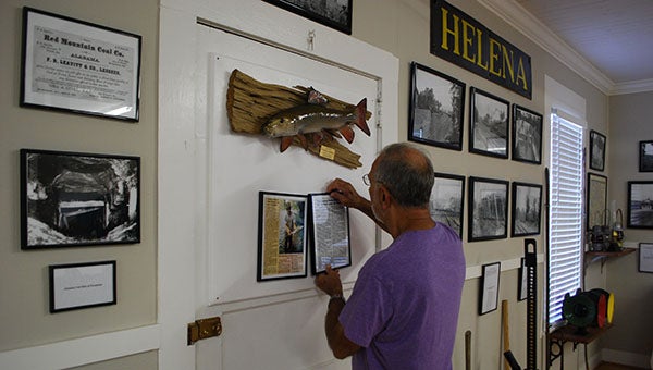 Helena Museum Curator Ken Penhale puts the finishes touches on the Redhorse exhibit in the Helena Museum. (Reporter Photo/Graham Brooks)