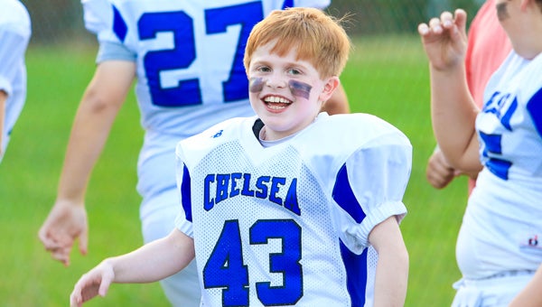 Gabe Griffin smiles before taking the field on Sept. 8 with his Chelsea White teammates. (For the Reporter / Dawn Harrison)